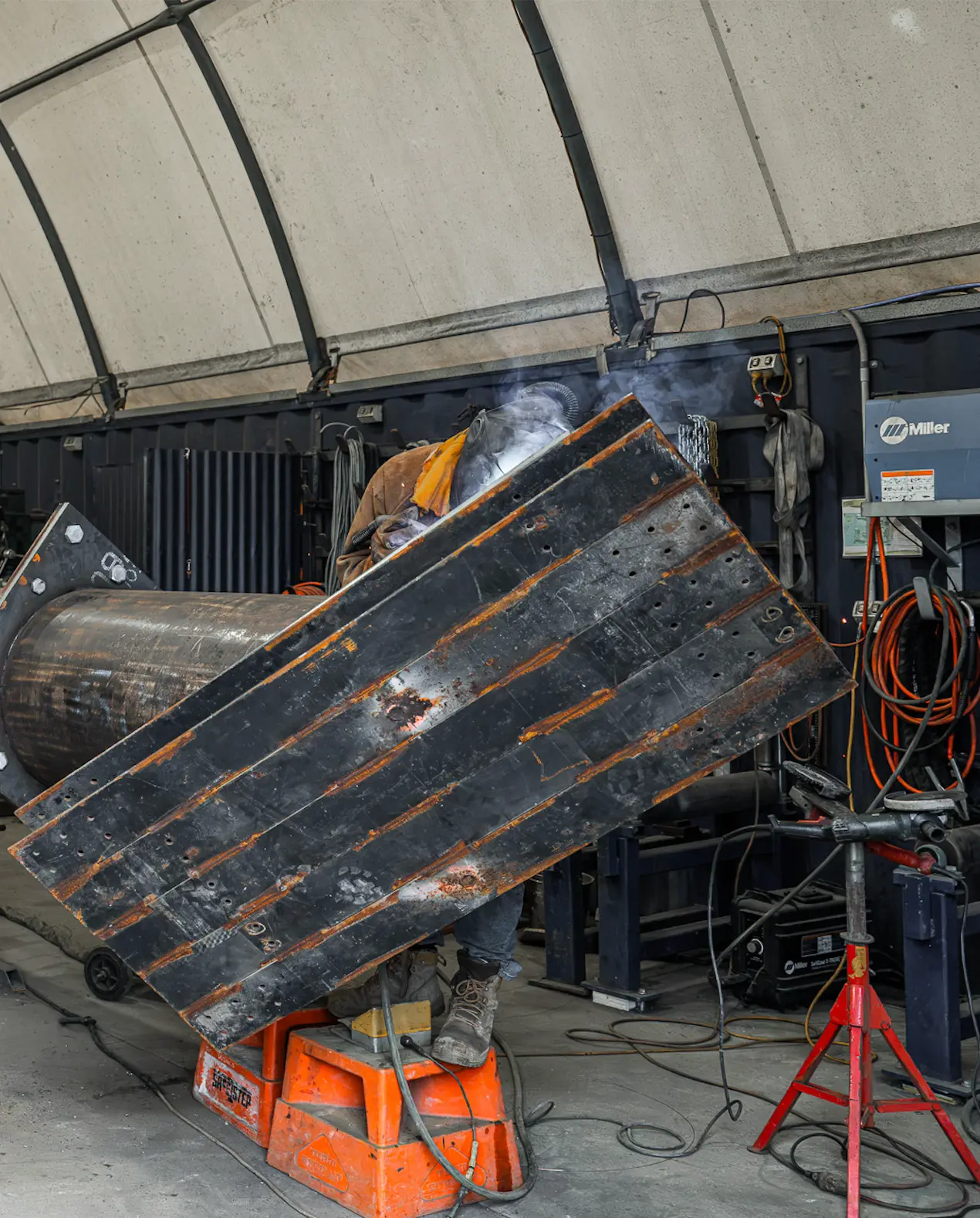 Welder fabricating a large steel component in the MXB Group workshop