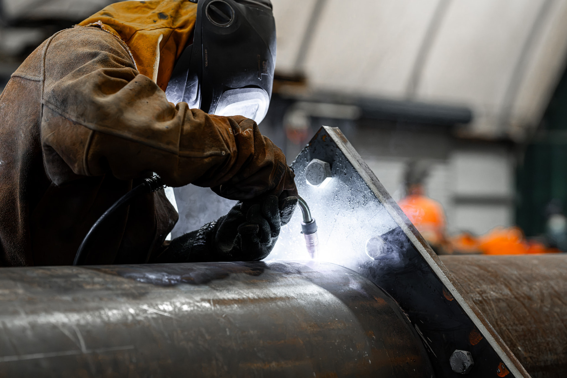 Certified welder joining a large diameter steel pipeline in the MXB Group workshop