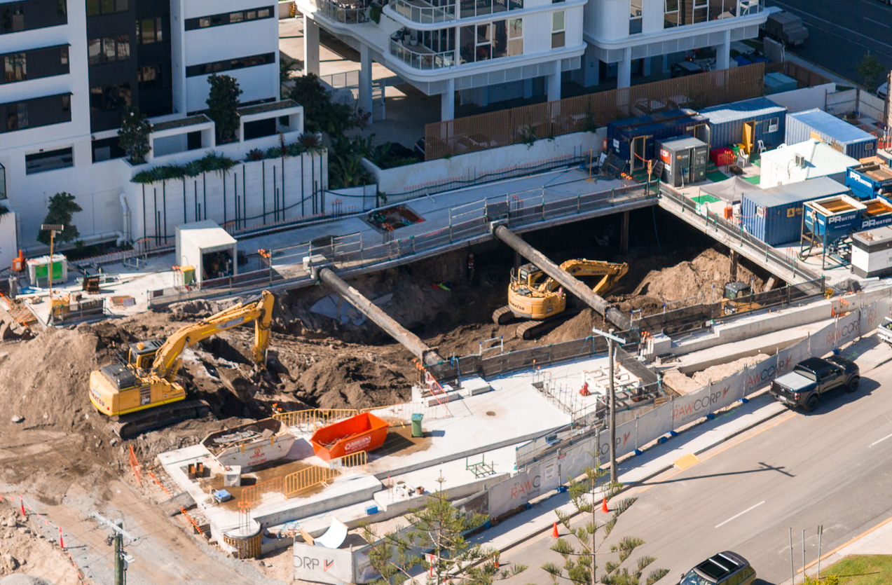 Deep high rise basement excavation supported by steel shoring and retaining beams