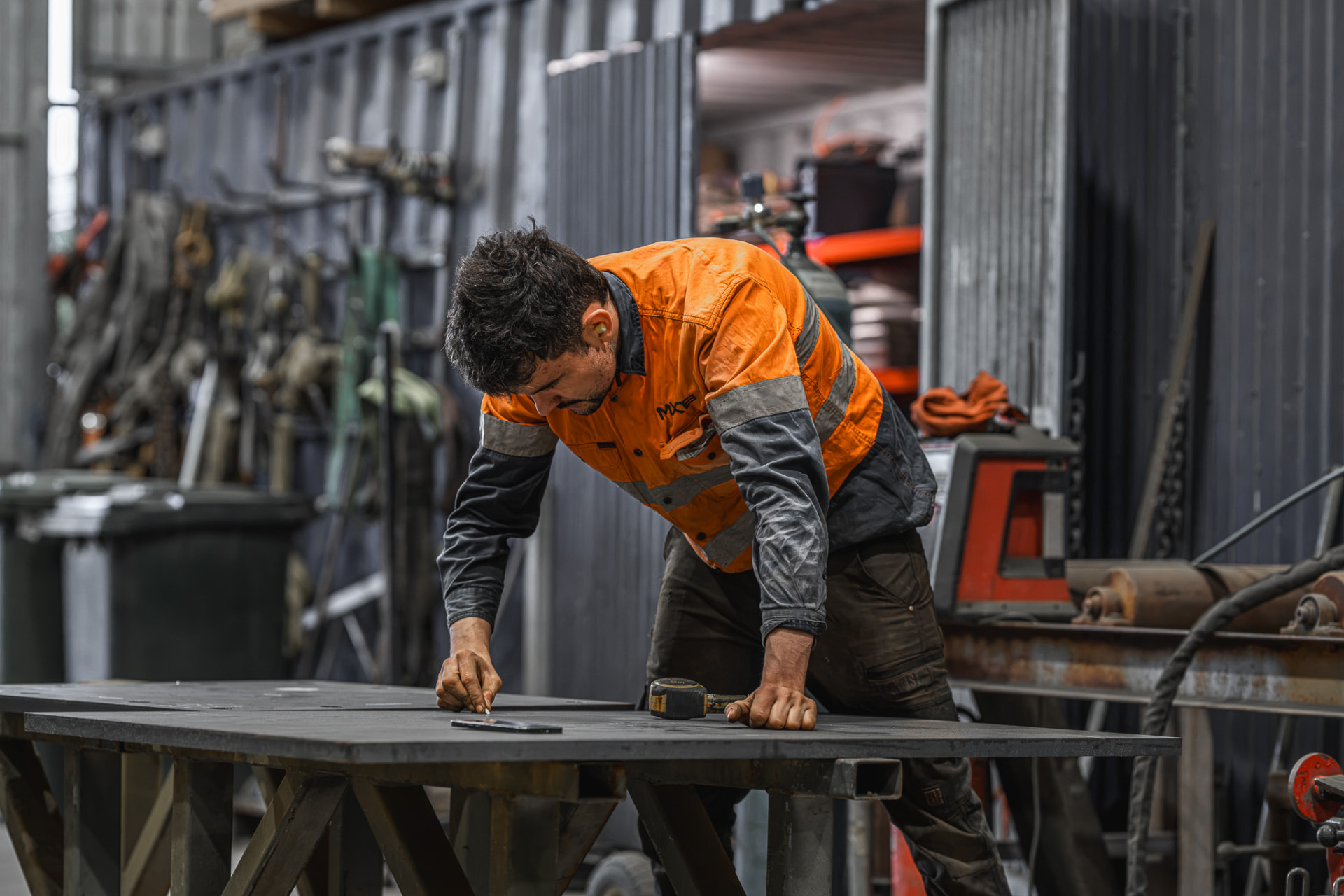 Tradesperson measuring steel in the workshop