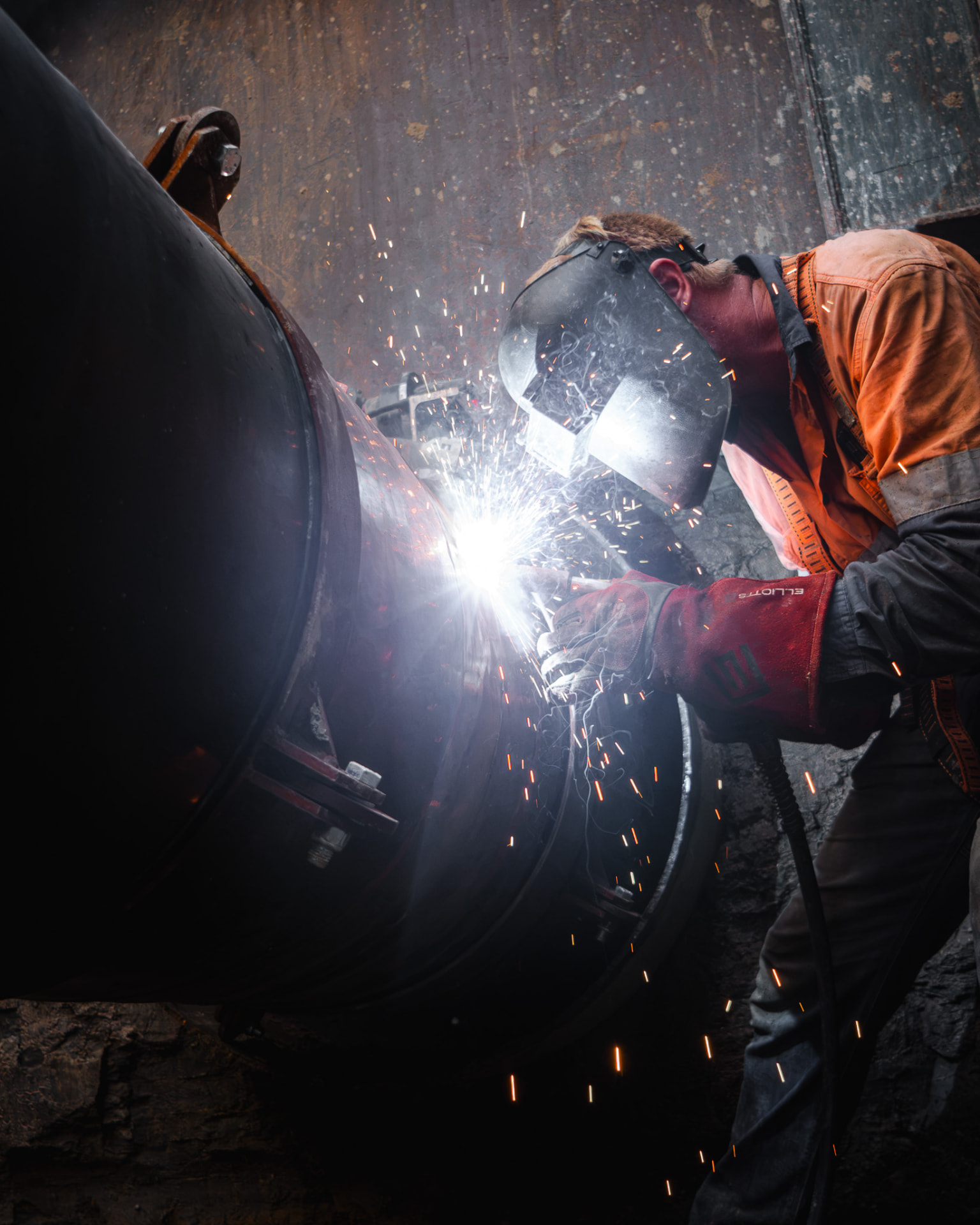 Certified welder joining a large diameter steel pipeline in the MXB Group workshop