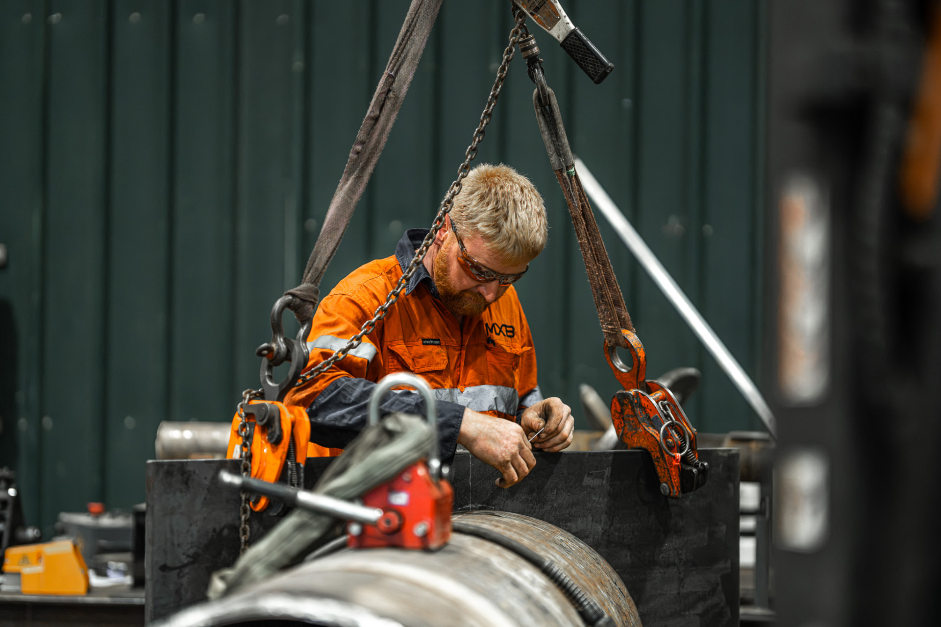 MXB Group fabricator working on a large steel pipe in the Hemmant workshop