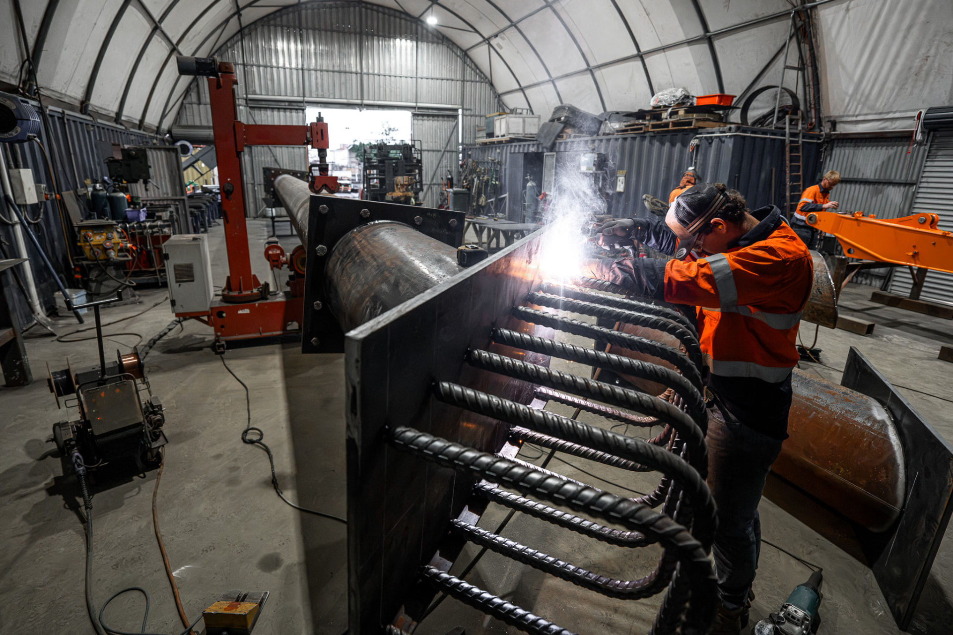 Welder fabricating a reinforced steel structure
