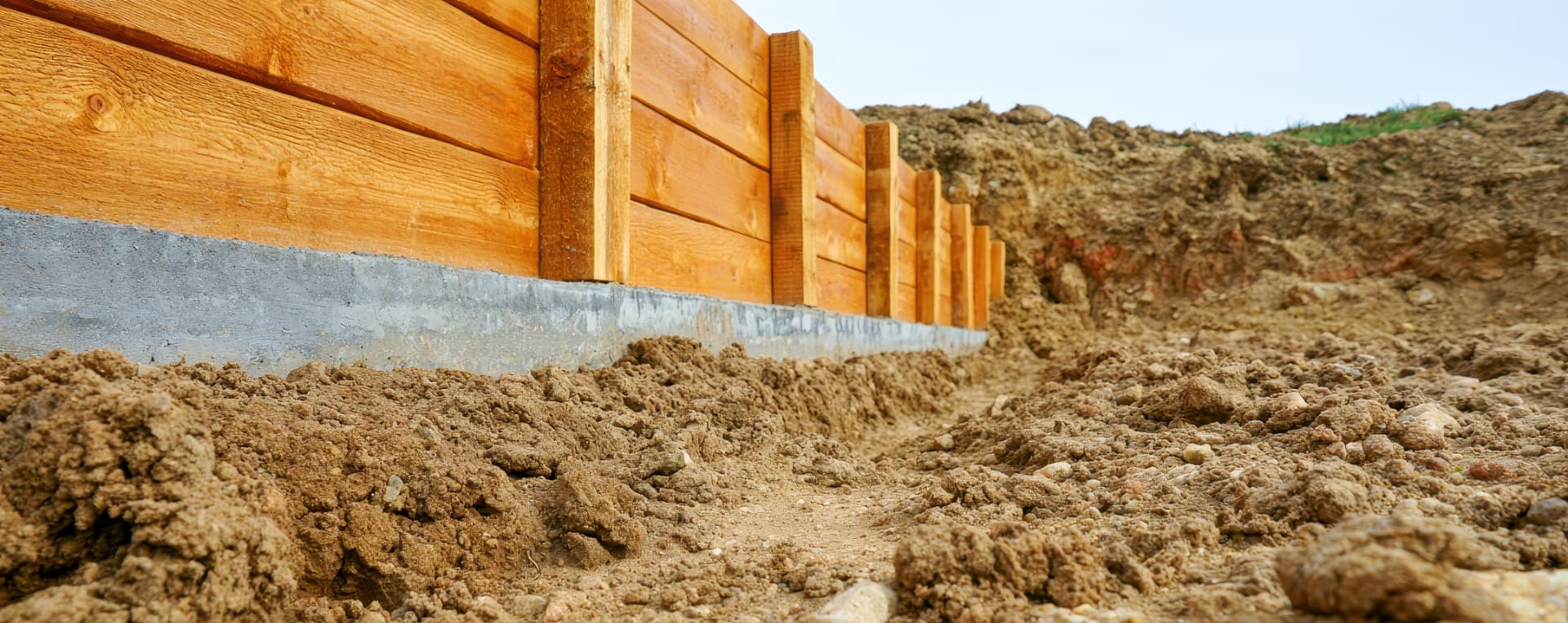Deep high rise basement excavation supported by steel shoring and retaining beams